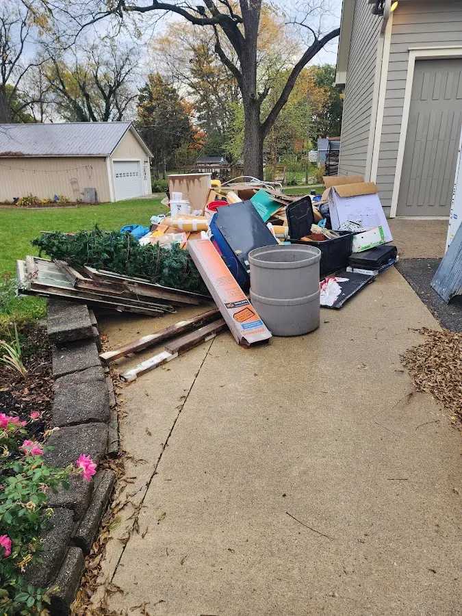 Dumpster being loaded with debris for Estate Cleanout Dumpster Rental in Talty